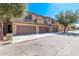 Desert townhome with three garages, neutral stucco, and desert landscaping at 705 W Queen Creek Rd # 1154, Chandler, AZ 85248