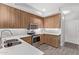 Well-lit kitchen features stainless steel appliances, wood cabinets, and neutral countertops at 705 W Queen Creek Rd # 1154, Chandler, AZ 85248