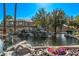 Scenic pond with a rocky waterfall and lush landscaping at 705 W Queen Creek Rd # 1154, Chandler, AZ 85248