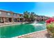 Scenic waterfront view with a fountain, lush landscaping, and community buildings at 705 W Queen Creek Rd # 1154, Chandler, AZ 85248