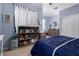 Bright bedroom featuring neutral walls, wood dresser, and a bookshelf displaying books and decorative items at 7274 W Alta Vista Rd, Laveen, AZ 85339