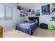 Bedroom featuring neutral walls, carpeting, a large window, and decorative posters on the wall at 7274 W Alta Vista Rd, Laveen, AZ 85339