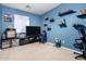 Bedroom featuring neutral walls, carpet, a large window, and shelving for displaying decorative objects at 7274 W Alta Vista Rd, Laveen, AZ 85339