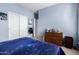 Bedroom with sliding closet doors, dresser, carpeting, neutral walls, and a window letting in natural light at 7274 W Alta Vista Rd, Laveen, AZ 85339