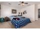 Comfortable bedroom showcases a patterned comforter, ceiling fan, and tiled floor at 7274 W Alta Vista Rd, Laveen, AZ 85339