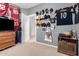 A sports-themed bedroom showcasing various jerseys, hats, and sports memorabilia on display at 7274 W Alta Vista Rd, Laveen, AZ 85339