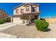 Inviting two-story home with a spacious driveway and xeriscaped front yard at 7274 W Alta Vista Rd, Laveen, AZ 85339