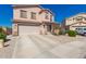 Two-story home featuring a two-car garage, desert landscaping, and well-maintained lawn at 7274 W Alta Vista Rd, Laveen, AZ 85339