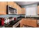 Close up of the kitchen features stainless steel appliances and black countertops at 7274 W Alta Vista Rd, Laveen, AZ 85339