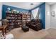 Comfortable living room featuring recliners, built-in bookshelves, and a large window at 7274 W Alta Vista Rd, Laveen, AZ 85339