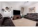 Spacious carpeted living room featuring recliners, TV, and neutral paint at 7274 W Alta Vista Rd, Laveen, AZ 85339