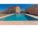 Large in-ground swimming pool surrounded by concrete decking and fencing for privacy and safety at 7274 W Alta Vista Rd, Laveen, AZ 85339