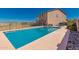 Swimming pool with a concrete deck and fenced perimeter; ideal for outdoor relaxation and recreation at 7274 W Alta Vista Rd, Laveen, AZ 85339