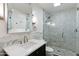 Bright bathroom with white marble counter tops, dark cabinets, and a tiled walk-in shower at 7937 E Solano Dr, Scottsdale, AZ 85250