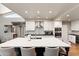 Well-lit kitchen featuring a marble countertop island, stainless appliances, and stylish cabinetry at 7937 E Solano Dr, Scottsdale, AZ 85250