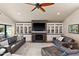 Inviting living room featuring a stylish fireplace, built-in shelving, and comfortable seating arrangement at 7937 E Solano Dr, Scottsdale, AZ 85250