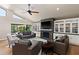 Bright living room features vaulted ceiling, fireplace, and large sliding glass door to outdoor patio at 7937 E Solano Dr, Scottsdale, AZ 85250