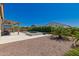 Landscaped backyard featuring a pool, covered patio, and desert plants, perfect for outdoor living and entertaining at 8025 W Gardenia Ave, Glendale, AZ 85303