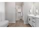 Well-lit bathroom features sleek white countertops, cabinets, and a view into a spacious, organized closet at 8025 W Gardenia Ave, Glendale, AZ 85303