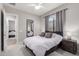 This bright bedroom features neutral tones, soft carpet, and a ceiling fan at 8025 W Gardenia Ave, Glendale, AZ 85303