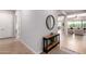 Inviting entryway featuring light tile floors, a stylish console table with decor, and views into the living spaces at 8025 W Gardenia Ave, Glendale, AZ 85303