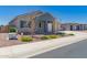 Charming single-story home with a two-car garage, desert landscaping, and a modern exterior paint scheme at 8025 W Gardenia Ave, Glendale, AZ 85303