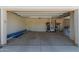 Spacious garage with ample storage and open doors leading to the outside at 8025 W Gardenia Ave, Glendale, AZ 85303