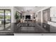 Modern kitchen features a black granite countertop and sink, seamlessly flowing into the living room at 8025 W Gardenia Ave, Glendale, AZ 85303