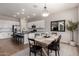 Bright kitchen with white cabinets, stainless steel appliances, and a central island with barstool seating at 8025 W Gardenia Ave, Glendale, AZ 85303