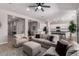 Inviting living room features neutral tones, modern ceiling fan, and seamlessly connects to the spacious kitchen at 8025 W Gardenia Ave, Glendale, AZ 85303