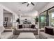 Inviting living room features neutral tones, modern ceiling fan, and seamlessly connects to the backyard at 8025 W Gardenia Ave, Glendale, AZ 85303