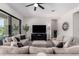 Spacious living room featuring neutral furnishings, a ceiling fan, and large windows for natural light and views at 8025 W Gardenia Ave, Glendale, AZ 85303