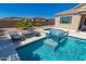 Luxurious pool and spa with a serene waterfall feature and comfortable lounge seating for outdoor relaxation at 8025 W Gardenia Ave, Glendale, AZ 85303