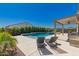 Relaxing poolside with lounge chairs and a beautiful view of the backyard and pergola at 8025 W Gardenia Ave, Glendale, AZ 85303