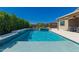 Beautiful pool with a waterfall feature and well-manicured hedges, perfect for relaxation and entertainment at 8025 W Gardenia Ave, Glendale, AZ 85303