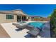 Inviting backyard with a refreshing pool, spa, and patio furniture, ideal for relaxation and outdoor gatherings at 8025 W Gardenia Ave, Glendale, AZ 85303