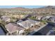 An aerial shot showcases homes with desert landscaping and stunning mountain views at 8857 S 167Th Ln, Goodyear, AZ 85338