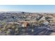 Overhead view of the community featuring desert landscaping, walking trails, a small lake, and scenic mountain views at 8857 S 167Th Ln, Goodyear, AZ 85338