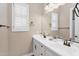 Bright bathroom featuring double sinks, white cabinets, quartz counters and shuttered windows at 8857 S 167Th Ln, Goodyear, AZ 85338