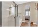 Modern bathroom featuring a walk-in shower, soaking tub, and a bedroom in the background at 8857 S 167Th Ln, Goodyear, AZ 85338