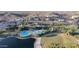 Aerial view of a resort-style community pool with winding slides, a splash pad, and palm trees in a desert landscape at 8857 S 167Th Ln, Goodyear, AZ 85338