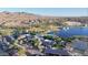 Panoramic aerial view of a Primary-planned community with a lake, pool, green spaces, and mountain views at 8857 S 167Th Ln, Goodyear, AZ 85338