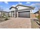 Attractive single-story home featuring a brick driveway and stone accents on the exterior at 8857 S 167Th Ln, Goodyear, AZ 85338