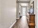 Elegant hallway featuring wood-look tile floors, tray ceilings, and a classic dresser at 8857 S 167Th Ln, Goodyear, AZ 85338