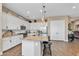 Beautiful kitchen featuring white cabinets, granite countertops, stainless steel appliances and a breakfast bar at 8857 S 167Th Ln, Goodyear, AZ 85338