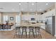 Spacious kitchen with stainless steel appliances, white cabinets, granite countertops, and bar seating at 8857 S 167Th Ln, Goodyear, AZ 85338