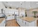 Bright kitchen with white cabinets, granite countertops, stainless steel appliances, and tile floors at 8857 S 167Th Ln, Goodyear, AZ 85338