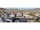 Street view of a well-maintained home with neutral paint, brick driveway and mountain views in the background at 8857 S 167Th Ln, Goodyear, AZ 85338