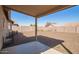 Spacious backyard includes gravel and a covered patio at 10792 W Elm Ln, Avondale, AZ 85323