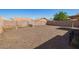 Gravel backyard, block wall, and mature landscaping at 10792 W Elm Ln, Avondale, AZ 85323